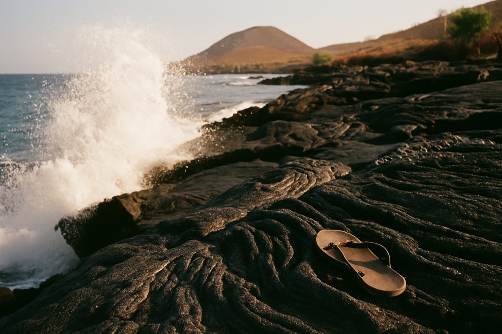 Volcanic shoreline with waves breaking on black lava rock